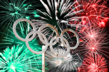 Fototapeta premium Olympic rings, italian flag colors, green white and red fireworks background, 2026 winter olympics Milan Cortina, olympic games symbol
