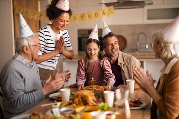 Family Celebrating Birthday With Cake and Smiles in a Cozy Home Setting
