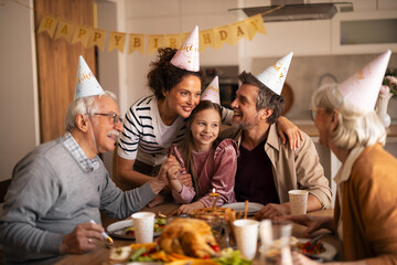 Fototapeta premium Multi-Generational Family Celebrating a Joyful Birthday at Home Together