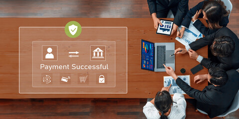 A diverse business team celebrates successful payment confirmation, collaborating with digital devices to analyze trends and strategize for enhanced productivity and growth. Trope