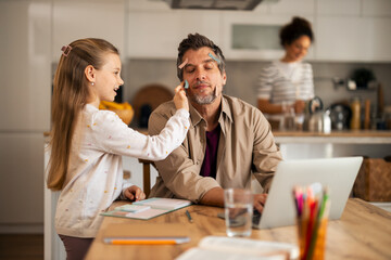 Father and Daughter Bonding in a Fun Home Office Moment