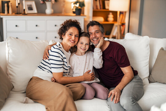 Happy Family Relaxing Together on a Comfortable Sofa at Home