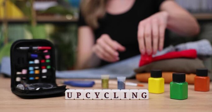 Crafting joy through upcycling as colorful thread and fabric come alive in creative hands at a sunny workspace filled with inspiration