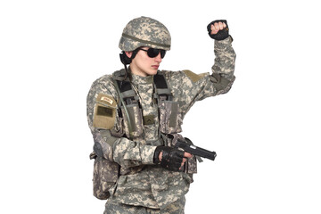 Obraz premium A soldier in full gear with a pistol in his hands raised his left hand up