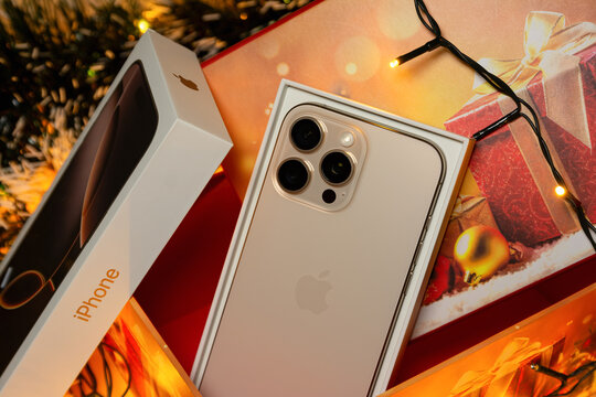 BURGAS, BULGARIA - NOVEMBER 28, 2025: Apple iPhone 16 Pro Max Desert Titanium on Christmas background. iPhone Christmas gift