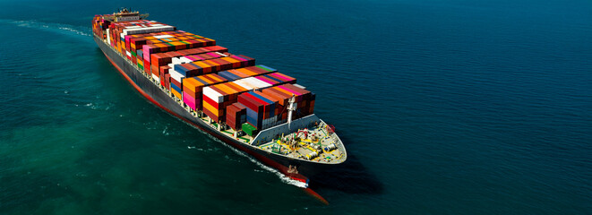 Aerial panoramic view of container cargo ship sailing in deep blue ocean for global business...