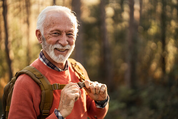 Smiling Elderly Man Enjoying Outdoor Hiking Adventure in the Forest