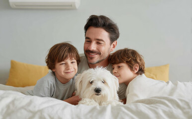 Happy father with two young son lying on bed with cute white dog. loving family with pet enjoying joyful, tender moment together at home in bedroom
