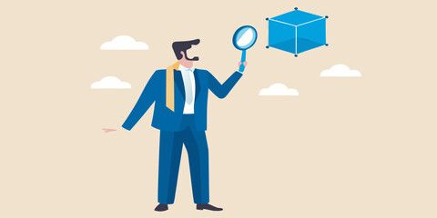 A businessman examines a blue isometric cube with a magnifying glass