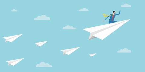 A businessman soaring through the sky on a paper airplane with others following © Lelin