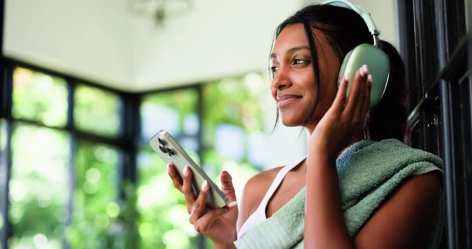 House, headphones and woman with exercise, smartphone and listening to music, app and subscription. Audio streaming, cellphone and person with smile, fitness or podcast with sound, dancing and radio