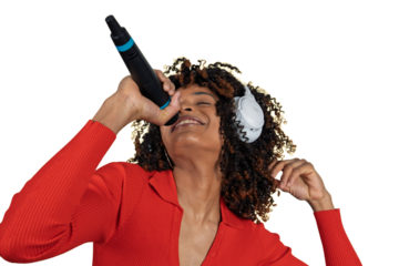 Happy woman singing with microphone and headphones