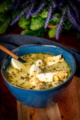 A bowl of soup sorrel with rice and boiled egg.