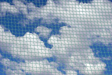 net against blue sky with clouds