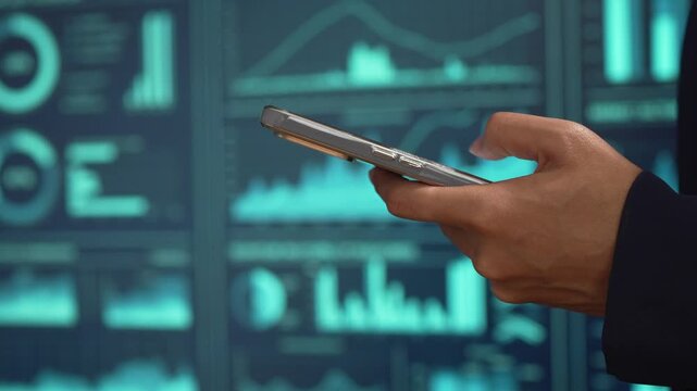 Professional individual woman in navy suit uses smartphone while standing, glowing digital dashboards, data analytics, futuristic interface elements, advanced technology for business intelligence.