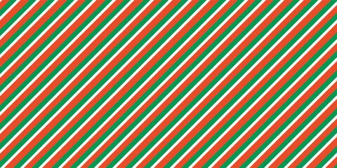 Christmas seamless pattern. Red and green diagonal stripes background. Candy cane repeating decoration wallpaper. Winter holiday lines backdrop modern abstract