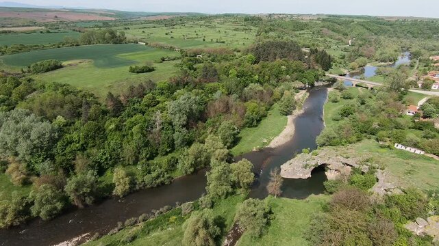 Spring drone video of the Rock Arch &ldquo;The Arch&rdquo; near Ăglen, showing the Slona rock formation, lush greenery, the karst landscape, and the winding Vit River, 2019