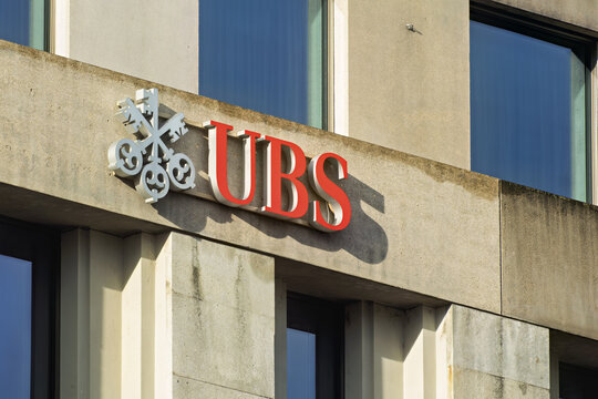 Geneva, Switzerland &ndash; December 10, 2025 : signs and logotype of Exterior of a building featuring the UBS logo, which consists of three keys and the letters "UBS" in red.