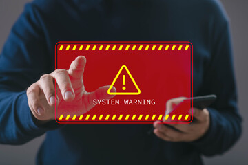 A hand interacting with a digital system warning alert displayed in red, symbolizing error notifications, cybersecurity threats, technical issues, and critical system failures in modern technology.