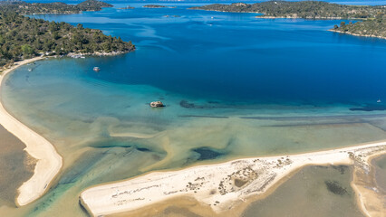 Aerial drone view of Fteroti Beach, sandbanks and lagoon in Sithonia, Chalkidiki, Greece