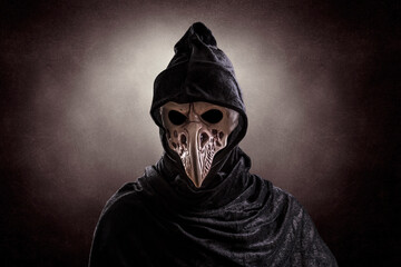 Creepy figure with animal bird skull over dark misty background