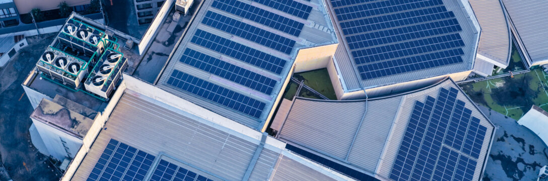 Solar roof, Solar on the roof, top view worker installing a solar cell on the factory roof, panels on tin roof seen from aerial view, panesl power.
