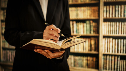 Professional woman reading open book inside library, information management, cataloging, knowledge organization, user guidance, literacy promotion, the expanding role of modern librarians in digital.