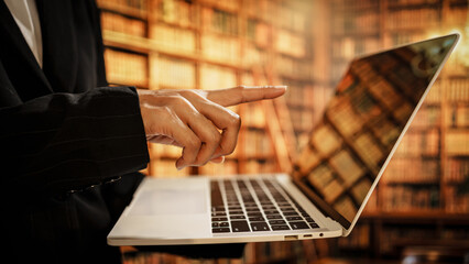 Professional woman using laptop inside library, digital resource organization, user assistance, literacy development, essential role librarians play in modern knowledge and data environments.