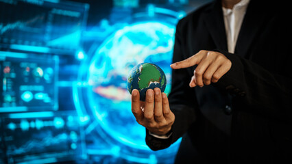Business professional holding small Earth model before futuristic digital interface, global responsibility,environmental awareness,world protection, sustainability, modern international collaboration