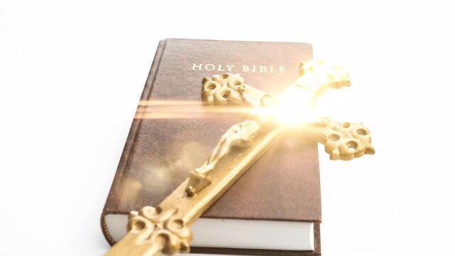 Holy Bible and Crucifix: Symbols of Christian Faith on White Background