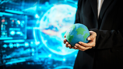 Business professional holding small Earth model before futuristic digital interface, global responsibility,environmental awareness,world protection, sustainability, modern international collaboration