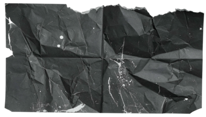A crumpled, torn piece of dark paper with white paint splatters and creases