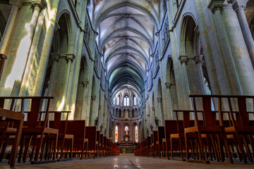 Church nave with rows of pews leading to the altar, showing historic detailed architecture
