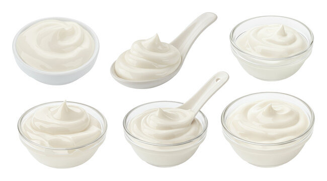 White creamy dairy in bowls and spoons, assorted servings of plain yogurt or sour cream