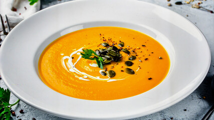 Creamy Pumpkin Soup with Seeds and Herbs for Premium Food Object and Autumn Cuisine