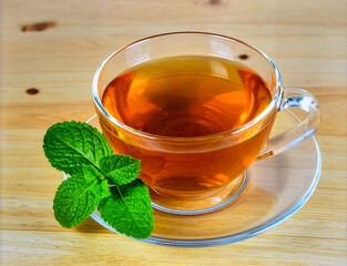 Cup of Herbal Tea with Fresh Mint Leaves on Wooden Table for Premium Relaxing Drink Object and Natural Beverage Concept