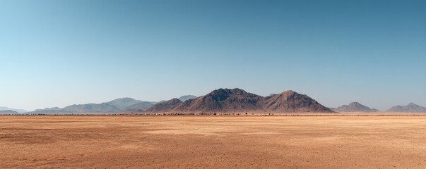 Wide desert landscape with distant rugged mountains under a clear sky, ideal for travel ads, nature presentations, and expansive scenic background scenes
