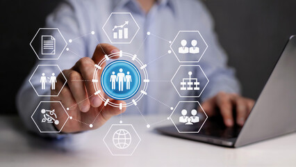 Businessman expertly managing human resources and organizational structure using digital interface near laptop