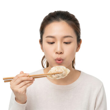 Young Asian Woman Enjoying a Dumpling with Chopsticks on White Background