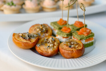 A luxury appetizer of caramelized peaches with nut crumbles