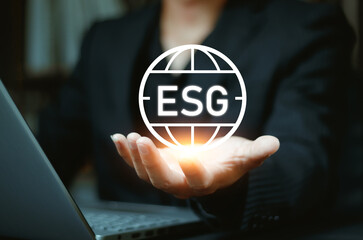 ESG environment social governance investment business concept. man use a computer to analyze ESG, surrounded by ESG icons .close to the computer screen in business investment strategy concept.