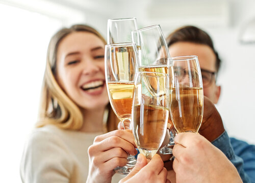 A portrait of young businesspeople or friends celebrating business success with a tost  in the office or young people having a party, teamwork and togetherness and having fun and friendship concept