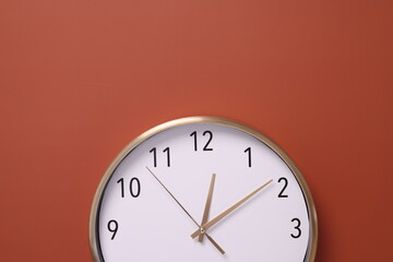 Close-up of a wall clock. The concept of time and work time is valuable for life, Alarm clock stopped. photo in a coloured background