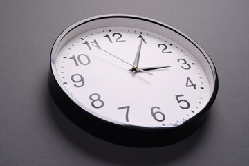 Close-up of a wall clock. The concept of time and work time is valuable for life, Alarm clock stopped. photo in a coloured background