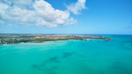 A stunning aerial view of the Mauritius landscape featuring panoramic perspectives of crystal-clear turquoise waters, tropical coastline, and lush island scenery