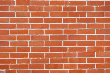 Background texture of an old yet clean red brick wall, with uniform white mortar joints. Ideal for vintage, industrial, urban, or construction-related design and copy space.