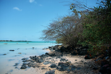 A beautiful idyllic seascape of Mauritius showcasing crystal-clear turquoise waters, gentle waves, and a serene tropical atmosphere. The scene reflects the island&rsquo;s natural beauty, calm ocean tones