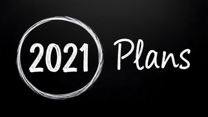 Chalk drawing of 2021 plans circled on a black chalkboard background for new year goal setting