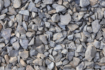 High-quality close-up texture background of angular rock or crushed stone aggregate, a foundational and versatile construction material used extensively for roads, concrete, and landscaping.