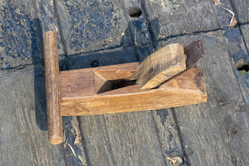 Close-up of a traditional Wooden Hand Plane (also called a Planer or Bench Plane), a classic carpentry tool crafted almost entirely of wood, used for shaping, smoothing, and flattening wood.